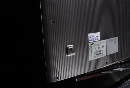 A textured back to a TV and a power button.
